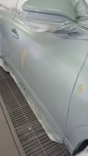 Car body in a fresh grey coat with the windows masked