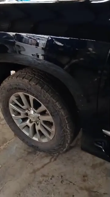 Black Toyota Land Cruiser being wiped down after spraying