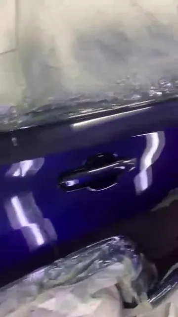Glossy deep blue car body with the lights and wheels masked
